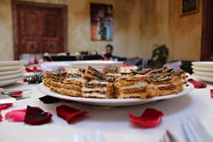 a plate of cake on a table with red flowers at Hostel Dream belko in Marrakesh