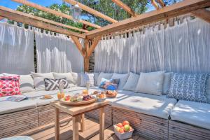 a patio with a couch and a table with food on it at ECO Aparthotel The Dreamers's Club in Lumbarda