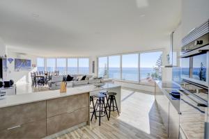 a kitchen and living room with a view of the ocean at Luz Beach Rooftop Penthouse in Luz