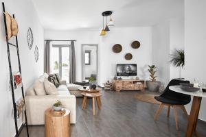a living room with a couch and a table at Pnoi Luxury Suites in Karterados