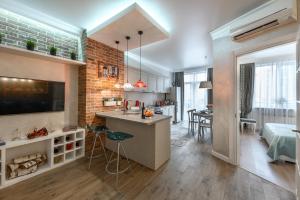 a room with a kitchen and a living room at Arkadia Plaza Design Apartment in Odesa