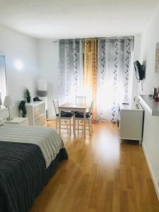 1 dormitorio con 1 cama, mesa y sillas en Resitur Luxury Suit 2, en Sevilla