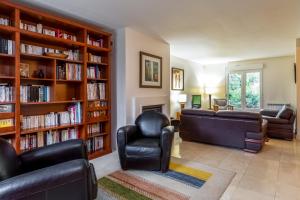 a living room with couches and bookshelves at 4 Bedroomed Near Disneyland Paris in Coupvray