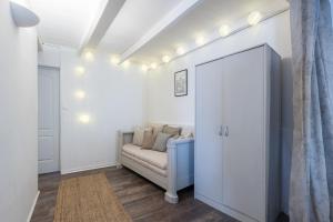 a living room with a couch and a door at Le Petit Bouchon in Parcoul