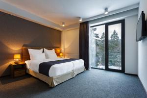 Voodi või voodid majutusasutuse AuRoom Bakuriani Resort toas