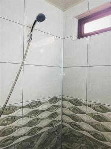 a shower with a shower head in a bathroom at Papazo in Kutaisi