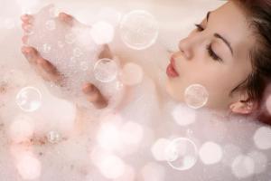 a woman bathing in a bath tub with bubbles at Elliott House Boutique Inn in Shaver Lake +45 photos