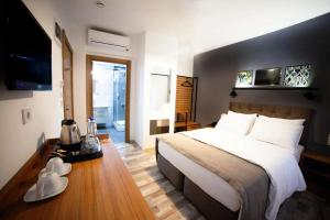 a hotel room with a bed, chair, and nightstand at Set Özer Hotel in Canakkale
