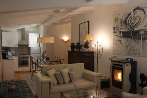 a living room with a couch and a kitchen at Casas Da Azenha in Vila Nova de Cerveira