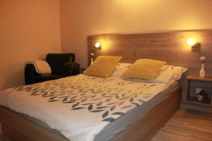 a bedroom with a large bed with a wooden headboard at Apartament Izabella in Suwałki