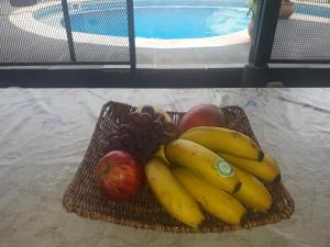 a basket of fruit sitting on a table at Sentirse en casa in Puerto Iguazú