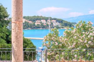 a view of a lake from a balcony at ECO Aparthotel The Dreamers's Club in Lumbarda