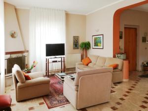 a living room with couches and a flat screen tv at Casale della Minaga in Agrigento