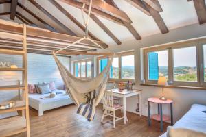 a room with a hammock in a tiny house at ECO Aparthotel The Dreamers's Club in Lumbarda +37 photos
