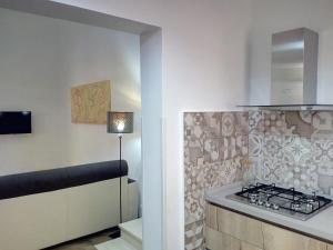 a kitchen with a stove and a counter top at Ancilinas House in Castellammare del Golfo