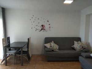 a living room with a couch and a table at R&G SALOU CENTER in Salou