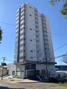 a tall white apartment building at Novo apto com 100 metros da Av. Brasil in Passo Fundo