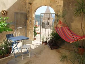 a patio with a hammock and a table and chairs at A' naca in Ragusa