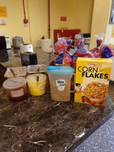 a counter with a box of corn flakes and other ingredients at Spacepod@hive in Singapore