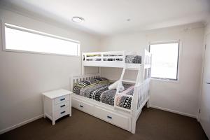 A bunk bed or bunk beds in a room at Heated Pool - Peaceful and Relaxing Beachside Family Entertainer