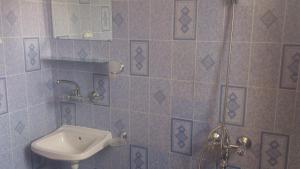 a bathroom with a sink and a toilet at Svetla Guest House in Primorsko +44 photos