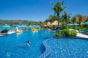 a person swimming in a swimming pool at a resort at Phi Phi CoCo Beach Resort in Phi Phi Islands