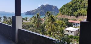 a view of the ocean from the balcony of a house at El Nido Royal Palm Inn in El Nido