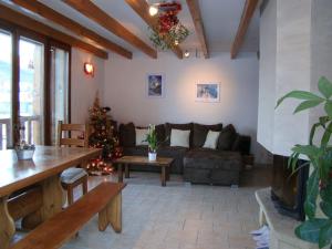 a living room with a christmas tree and a couch at Les Sens Ciel in Corrençon-en-Vercors