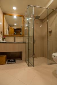 a bathroom with a glass shower and a toilet at Gilgit Serena Hotel in Gilgit