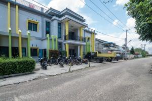 un gruppo di motocicli parcheggiato di fronte a un edificio di RedDoorz near Sultan Thaha Airport Jambi a Jambi