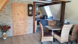 a kitchen with a table and chairs and a door at Ferienhaus am Lübbesee in Milmersdorf +12 photos