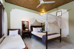 Ein Bett oder Betten in einem Zimmer der Unterkunft Rumah Roda