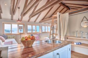 a kitchen with a bowl of fruit on a counter at ECO Aparthotel The Dreamers's Club in Lumbarda