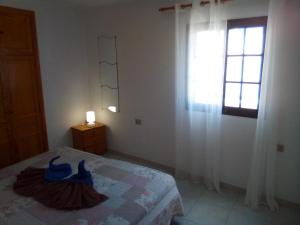 a bedroom with a bed and a window at Casa Pilar 1 bed in San Bartolomé