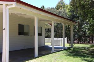 a porch of a white house with a roof at Sapphire Chalets, Augusta in Augusta