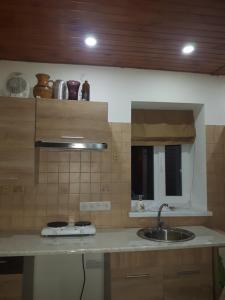a kitchen with a sink and a counter top at Киевская 43 in Khorol