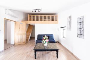 a living room with a blue couch and a table at chez nico in Bédoin +18 photos
