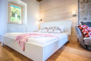 a bedroom with a white bed and a window at ECO Aparthotel The Dreamers's Club in Lumbarda