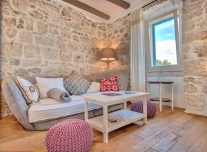 a living room with a couch and a table at ECO Aparthotel The Dreamers's Club in Lumbarda
