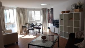 a living room with a table and chairs in it at Apartment Plaza Del Salvador in Seville