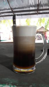 a mug of coffee sitting on a table at Elephant and Four wise men resort in Neil Island