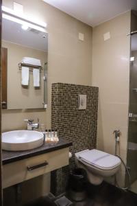 a bathroom with a sink and a toilet at Hotel Abode in Amritsar