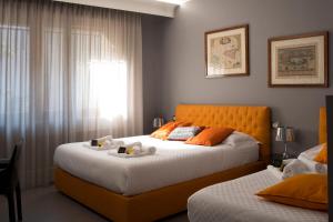 a bedroom with two beds and a window at Principessa Mafalda in Messina