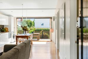 a living room with a couch and a table at Geelong West Miner's Cottage in Geelong