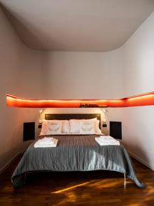1 dormitorio con 1 cama con luces en la pared en Carlotta Station Suite, en Bolonia