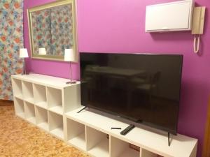 a large flat screen tv sitting on a white entertainment center at Apartamento "CASA ALICIA" in Vecindario