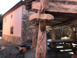 a wooden pole with a picnic table in front of a building at Las Tres Luces Casa 1 in Llanes +11 photos