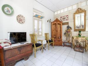 a living room with a tv and a fireplace at Reddoorz Syariah near Wijilan Yogyakarta in Yogyakarta