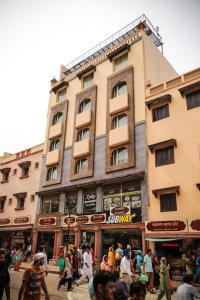 a group of people walking in front of a building at Hotel Abode in Amritsar