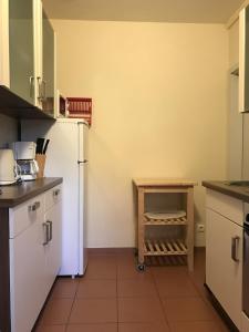 uma cozinha com um frigorífico branco e uma prateleira em Ferienwohnung-Strandspaziergang, kleine Wohnung em Börgerende-Rethwisch